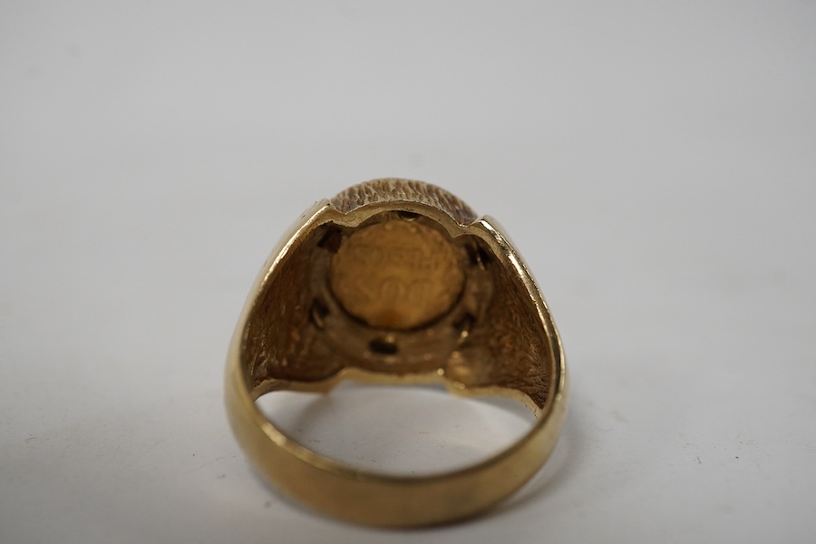 A 9ct gold ring set with a gold Mexican Two Peso coin, size R1/2, British hallmarks, gross weight approximately 9 grams. Condition - good, some scratches